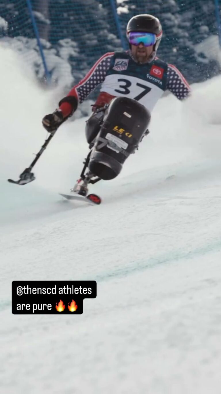 An NSCD sit-skier racing down a groomed course